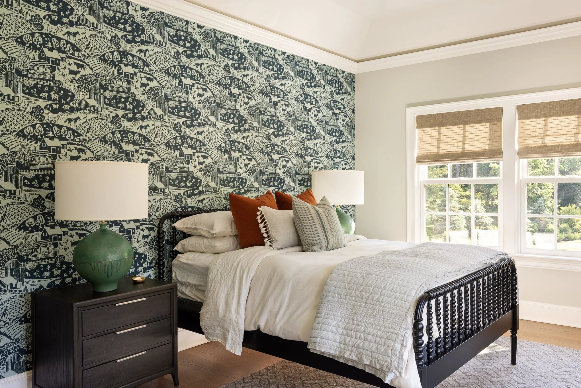 Bedroom with green and white scenic wallpaper, spindle bed, and layered pillows — Moonlight project.